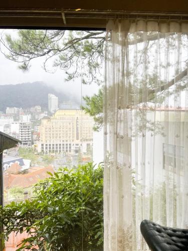 a window with a view of a city at Dreamy Homestay Tam Đảo in Tam Ðảo
