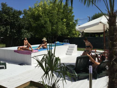 a group of people sitting around a swimming pool at B&B Isonzo in Turriaco