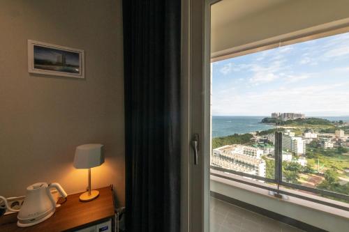 a room with a window with a view of the ocean at 모어댄 속초해변점 in Sokcho