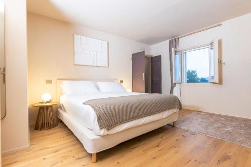 a bedroom with a large bed and a window at Castello di Ribano Le Dimore in Savignano sul Rubicone