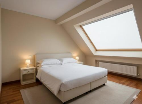 a bedroom with a large bed with a large window at Hotel Terme Patria in Abano Terme