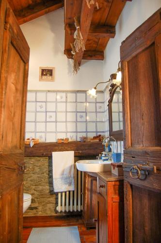 a bathroom with a sink and a toilet at Chalet La Baita in Baceno