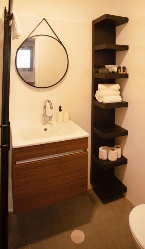 a bathroom with a sink and a mirror at Sublet TLV 270 in Tel Aviv