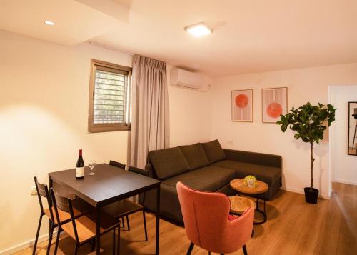 a living room with a couch and a table at Sublet TLV 270 in Tel Aviv