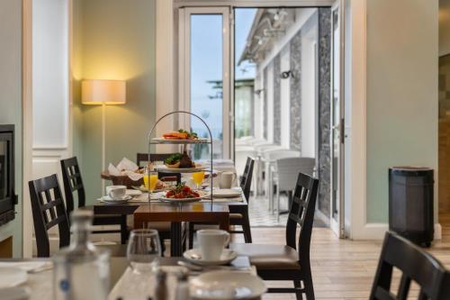 a dining room with a table with food on it at OurMadeira - Babosas Village, gardénias and greenspaces in Funchal
