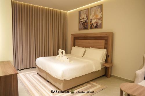 a bedroom with a bed with a stuffed animal on it at SAS Central in Salalah
