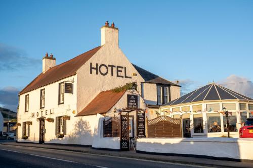 a hotel sitting on the side of a street at The Upper Largo Hotel & Restaurant in Lundin Links