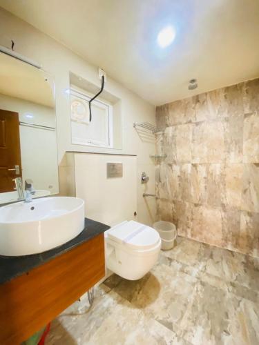 a bathroom with a white toilet and a sink at Casa Nube Resort Munnar in Munnar