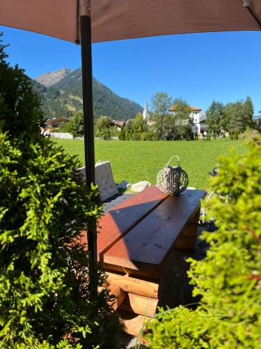 a picnic table with a basket on top of it at Appartements Bergliebe in Bichlbach