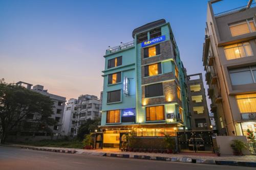 a building with a sign on the side of it at FabHotel Prime Familto - Near Bisarjan Ghat in kolkata