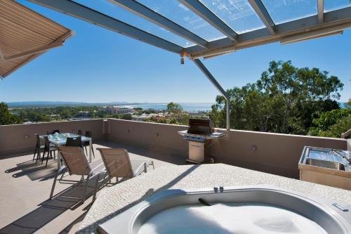 a hot tub on the roof of a house at Picture Point Terraces in Noosa Heads