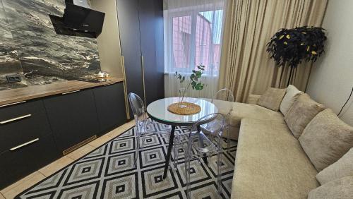 a living room with a couch and a table at Black Room Apartment in Mukacheve