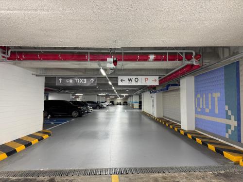 an empty parking garage with cars parked in it at 모어댄 속초해변점 in Sokcho