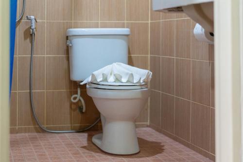 a white toilet in a bathroom with a shower at Oceanview Bungalows by EAT in Karon Beach