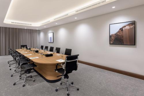 a large conference room with a long table and chairs at Holiday Inn Riyadh The Business District by IHG in Riyadh