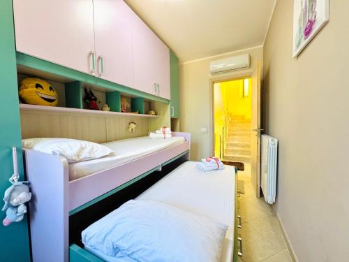 a room with two bunk beds and a hallway at La Cinisara in Carini