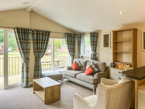 a living room with a couch and a table at Glen View Lodge in Innerwick