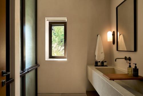 a bathroom with a sink and a window at Mantri Villa, a Celestial Retreat with Endless Blue, By ThinkVilla in Neokhórion