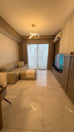 a large living room with a couch and a television at Z Loft Skyhouse BSD in Samporo