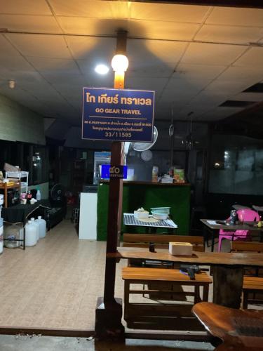 a sign in the middle of a room with a restaurant at Go Gear Travel & Bungalow in Krabi town