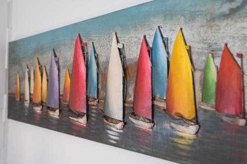 a painting of a row of colorful surfboards at Apartment PLAZA -Wallbox 11kW- Private SPA- Jacuzzi, Infrared Sauna, Luxury massage chair, Parking, Entry with PIN 0 - 24h, FREE CANCELLATION 24 hours before Check In,Premium pillows and mattress in Slavonski Brod