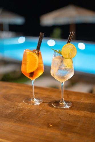two cocktails sitting on top of a wooden table at Bujtina Adora in Ara të Lumit