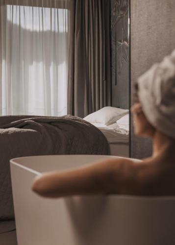 a woman standing in front of a mirror in a room at GOING TRIPLE A apartments WEST in Going