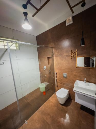 a bathroom with a toilet and a shower and a sink at Akshaya Homestay in Trichūr