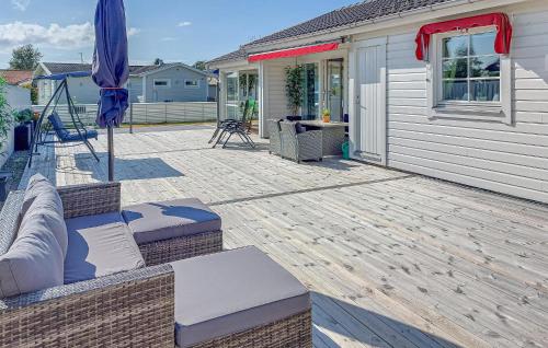 a patio with a couch and an umbrella at 3 Bedroom Beautiful Home In Falkenberg in Stora Hansagård