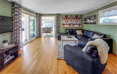 a living room with a couch and a table at 3 Bedroom Beautiful Home In Falkenberg in Stora Hansagård