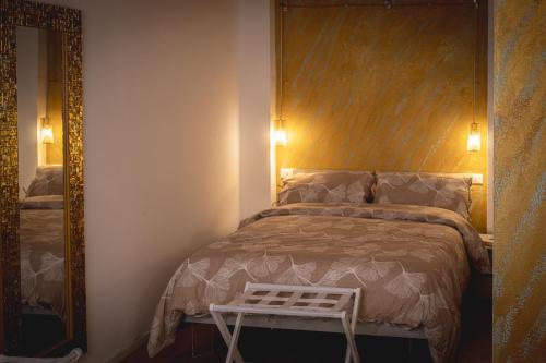a bedroom with a bed with a wooden headboard and a mirror at Casa Vincenza in Ravenna