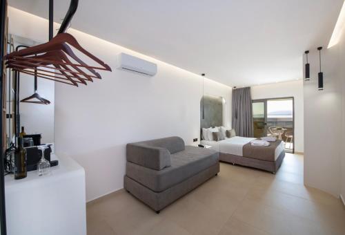 a living room with a couch and a bed at Zorbas Lifestyle Hotel in Georgioupolis