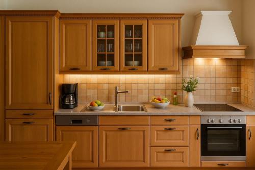 a kitchen with wooden cabinets and a sink at Auhäusl Residence for 6 with private Sauna by Belle-Stay in Reith bei Kitzbühel