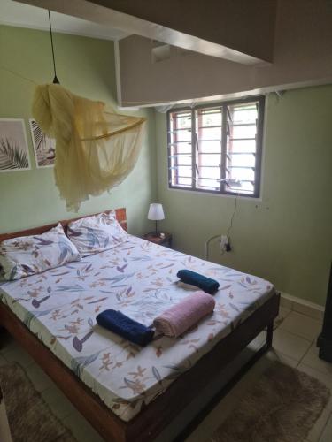 a bed with two pillows on it in a bedroom at Diani Beach Walk in Diani Beach