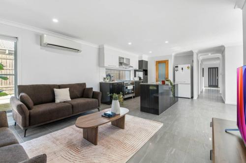 a living room with a couch and a table at Grand and Serene Family Stay with Alfresco Living in Doolandella