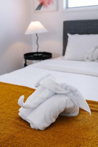 a white towel is laying on a bed at Grand and Serene Family Stay with Alfresco Living in Doolandella