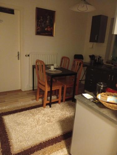 a kitchen with a table and two chairs and a table at B&Bestradas in Vaggeryd