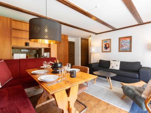 a living room with a table and a couch at Apartment Opale 4 by Interhome in Villars-sur-Ollon