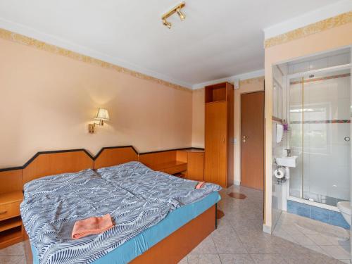 a bedroom with a bed and a shower at Holiday Home Sezímky by Interhome in Stvolínky