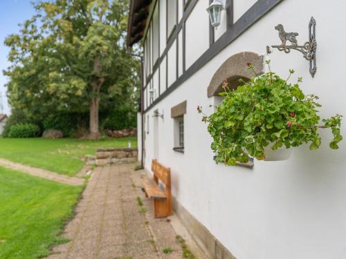 a white building with a bench and a window at Holiday Home Sezímky by Interhome in Stvolínky