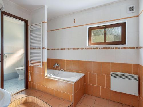 a bathroom with a tub and a sink and a toilet at Holiday Home Loukov u Semil by Interhome in Loukov