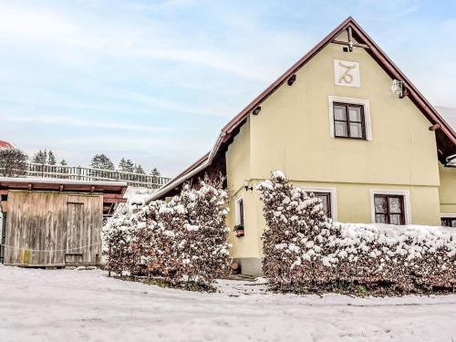 a house with snow on the side of it at Holiday Home Loukov u Semil by Interhome in Loukov