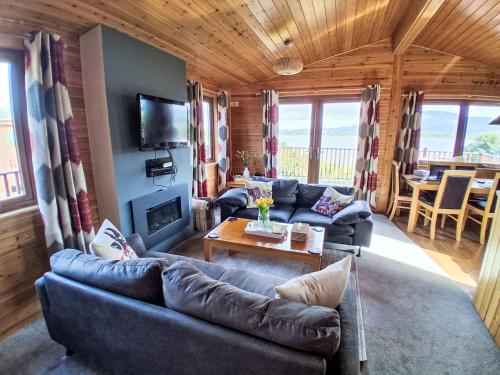 a living room with a couch and a table at Chalet Loch Leven Lodge 12 by Interhome in Kinross