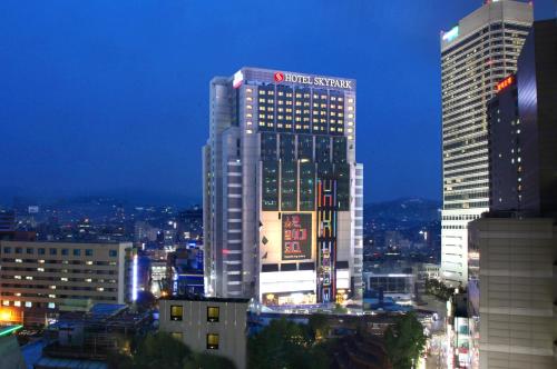 a tall building with a sign on it in a city at Hotel Skypark Kingstown Dongdaemun in Seoul