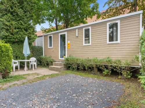 a small house with a table and an umbrella at Holiday Home Florida by Interhome in Prague