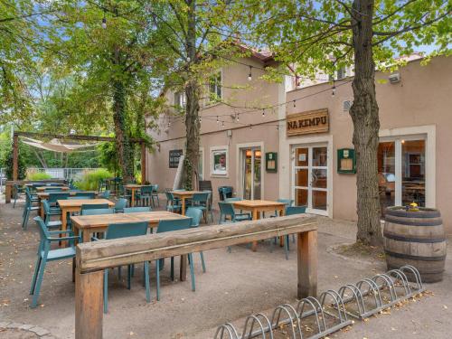 a bench in front of a restaurant with tables and chairs at Holiday Home Florida by Interhome in Prague