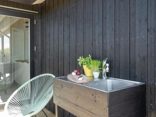a bathtub with a bowl of fruit and a chair at Holiday Home Gubbe - 500m from the sea by Interhome in Lakolk
