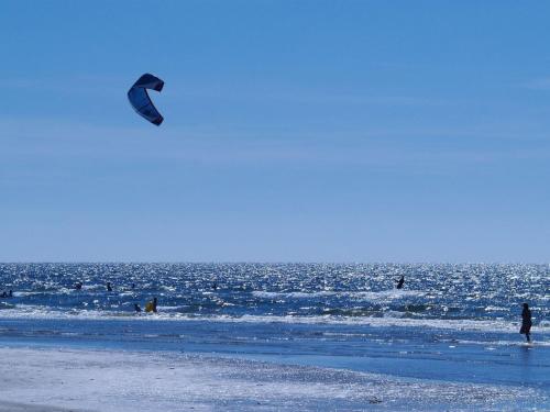 a person is flying a kite on the beach at Holiday Home Gubbe - 500m from the sea by Interhome in Lakolk