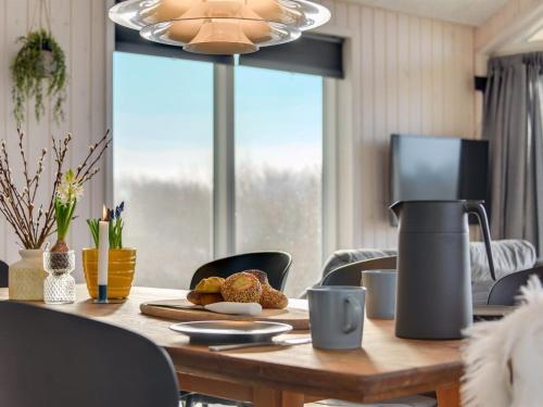a dining room table with a coffee maker on it at Holiday Home Gubbe - 500m from the sea by Interhome in Lakolk