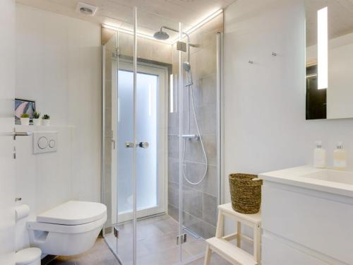 a bathroom with a shower and a toilet and a sink at Holiday Home Gubbe - 500m from the sea by Interhome in Lakolk